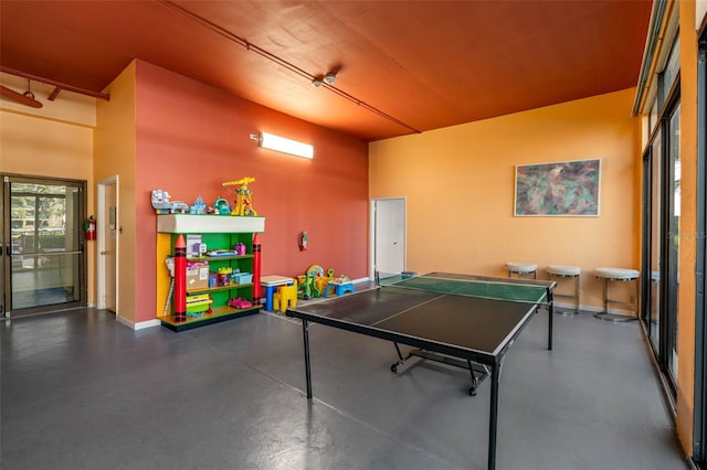 recreation room with a high ceiling