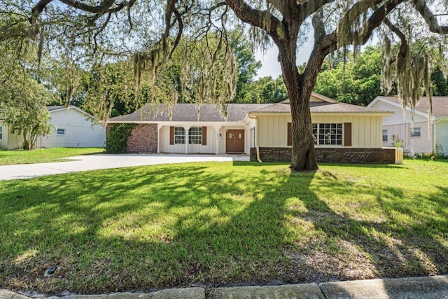 single story home with a front yard and a garage