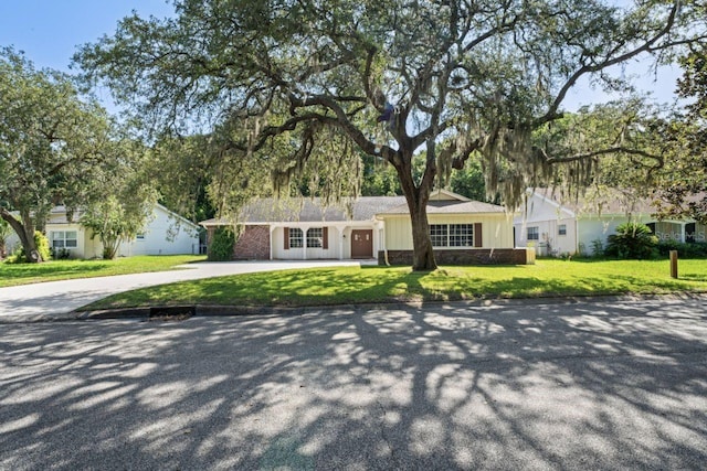 ranch-style house featuring a front yard and a garage