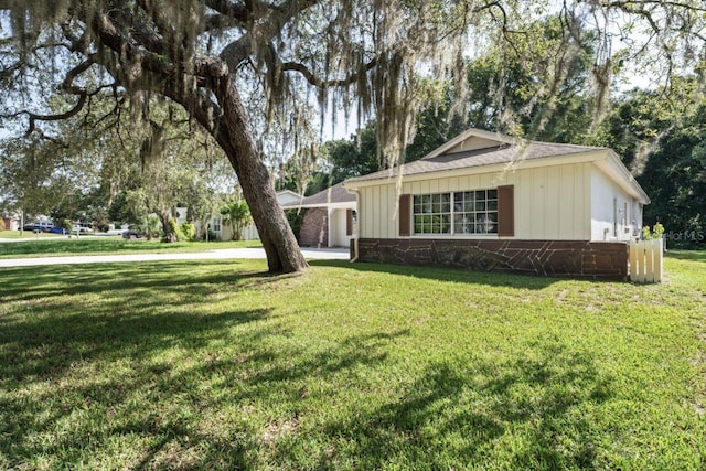 view of side of home with a lawn