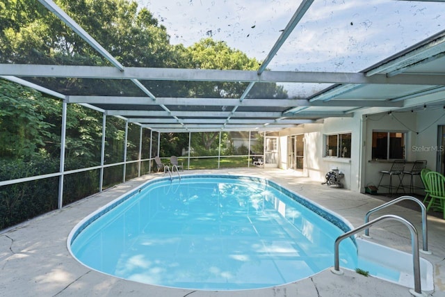 view of pool featuring a patio area and a lanai