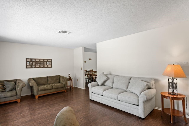 living room featuring a textured ceiling and hardwood / wood-style floors