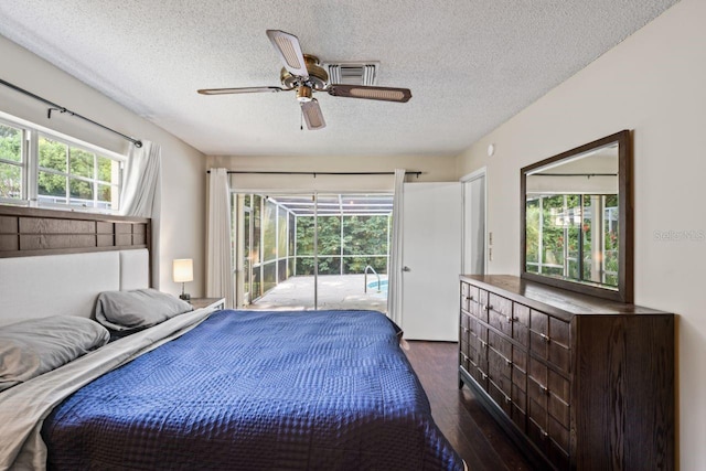 bedroom with ceiling fan, dark hardwood / wood-style flooring, access to outside, and multiple windows