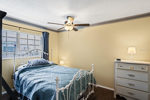 bedroom with ceiling fan, crown molding, a textured ceiling, and dark wood-type flooring