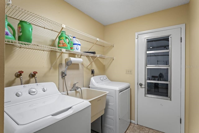 washroom with sink, light tile patterned floors, and independent washer and dryer