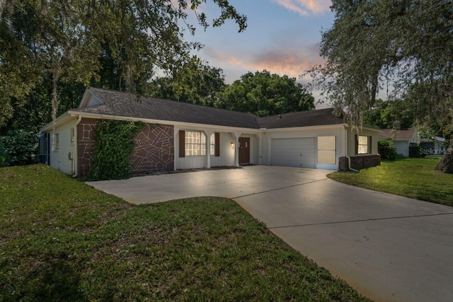 12912 Willoughby Ln, Hudson, FL 34667 - ranch-style home featuring concrete driveway, a front yard, and a garage
