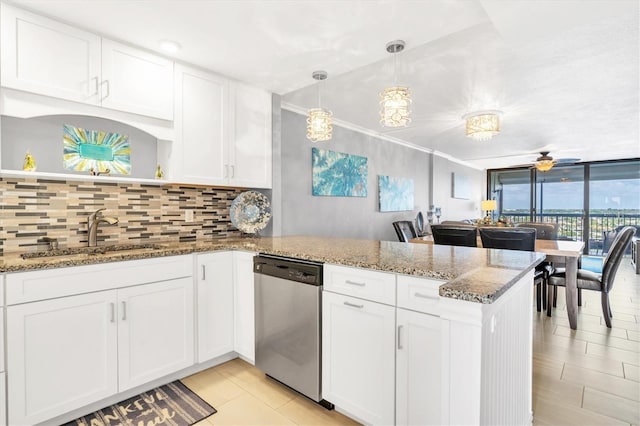 kitchen with sink, stainless steel dishwasher, white cabinets, and kitchen peninsula