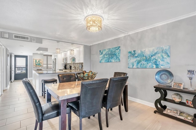 dining area featuring ornamental molding