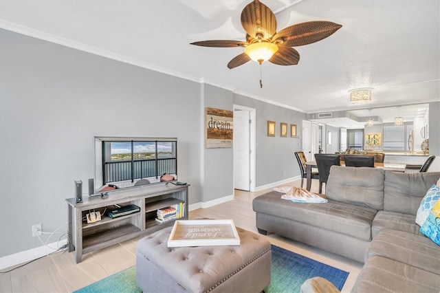 living room with ornamental molding and ceiling fan