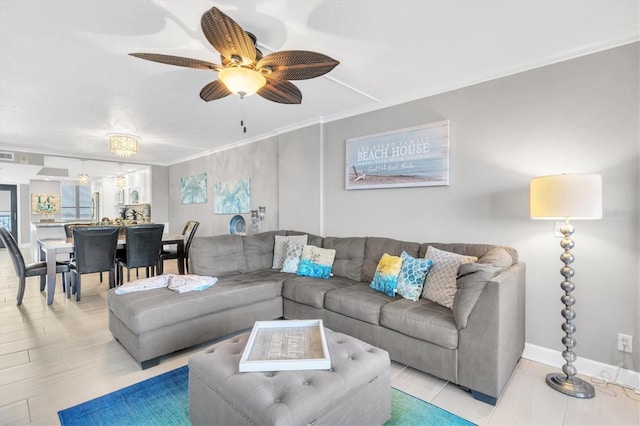 living room featuring crown molding and ceiling fan