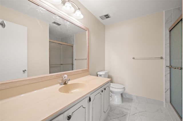 bathroom with a shower with shower door, toilet, and vanity