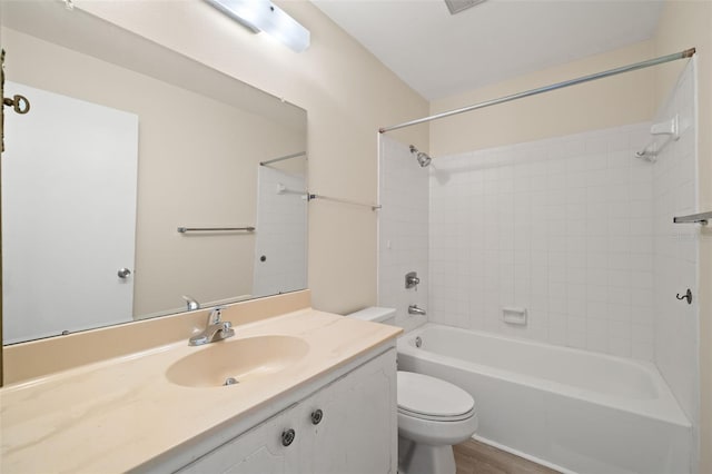 full bathroom with vanity, toilet, tiled shower / bath combo, and hardwood / wood-style floors