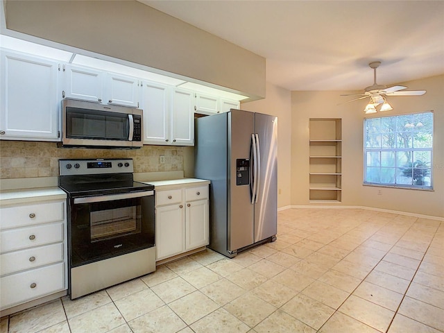 kitchen with appliances with stainless steel finishes, decorative backsplash, white cabinets, and light tile patterned floors