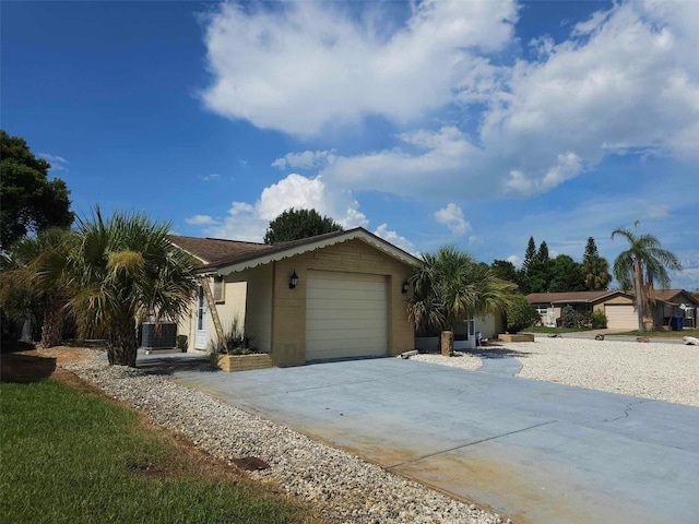 view of home's exterior with a garage and central air condition unit