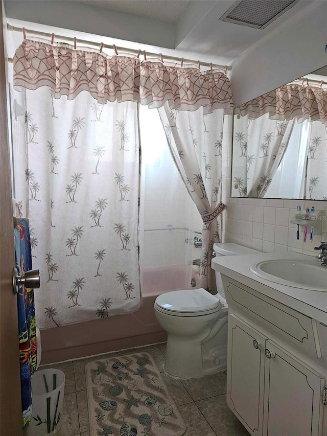 full bathroom featuring shower / bath combo with shower curtain, decorative backsplash, tile patterned floors, toilet, and vanity