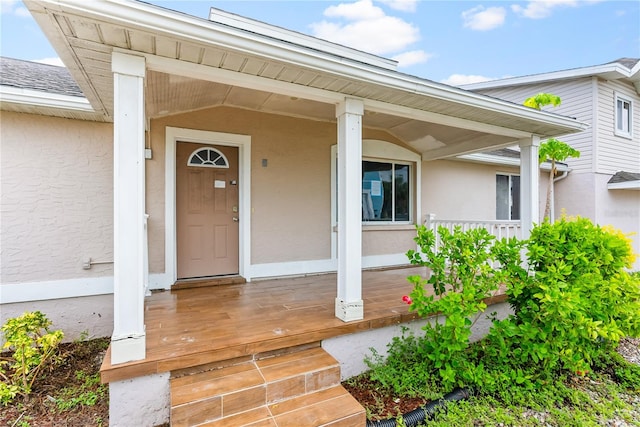 view of exterior entry with a porch