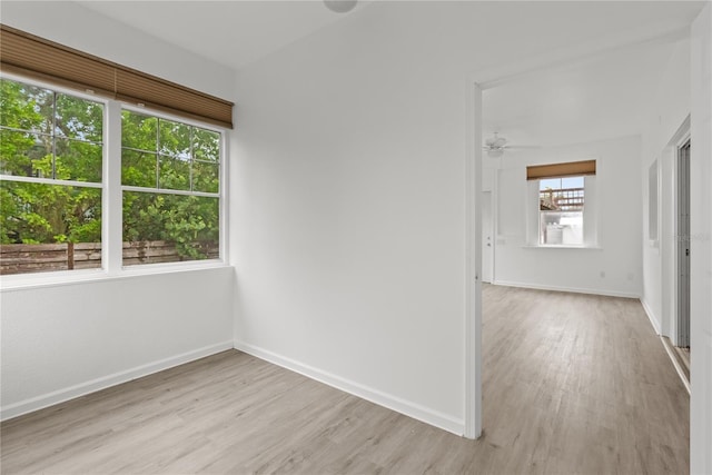 unfurnished room with ceiling fan and light wood-type flooring