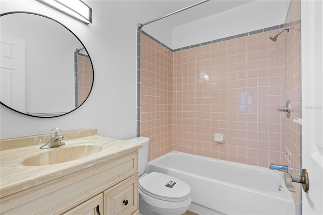 full bathroom with tiled shower / bath combo, vanity, and toilet