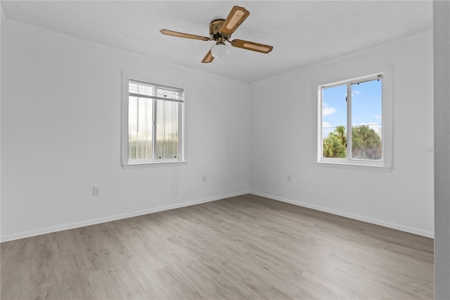 spare room featuring a textured ceiling, light hardwood / wood-style flooring, and ceiling fan