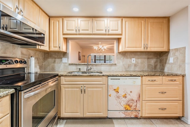 kitchen featuring light stone counters, stainless steel appliances, sink, and light brown cabinets