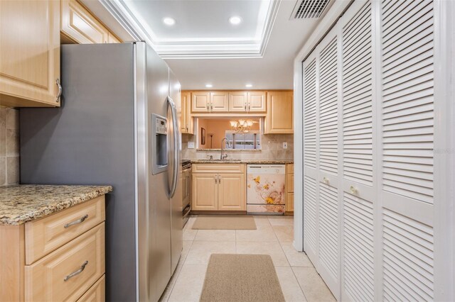 kitchen with light brown cabinetry, light tile patterned flooring, backsplash, stainless steel appliances, and sink