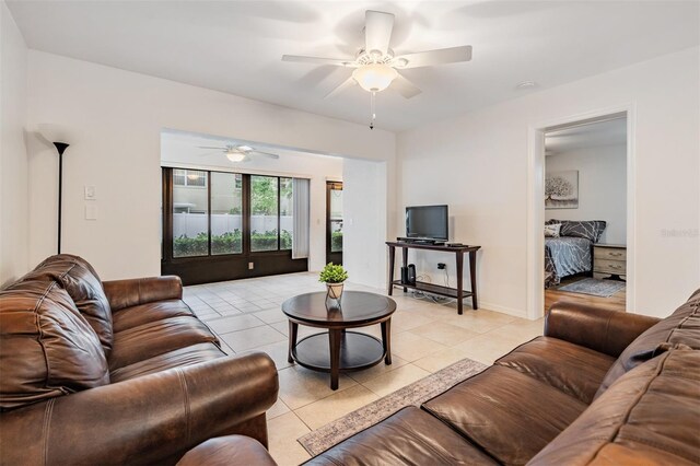 tiled living room featuring ceiling fan