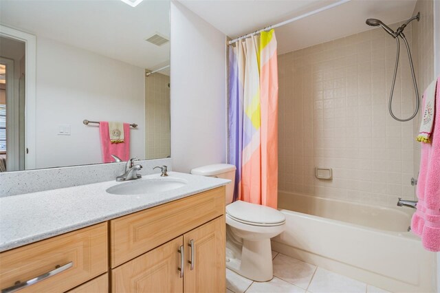 full bathroom with shower / tub combo with curtain, vanity, tile patterned floors, and toilet