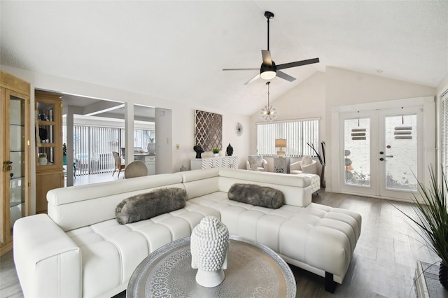 living room with ceiling fan, french doors, lofted ceiling, and hardwood / wood-style flooring