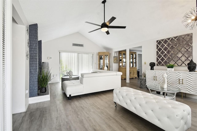 bedroom with dark hardwood / wood-style flooring, vaulted ceiling, and ceiling fan