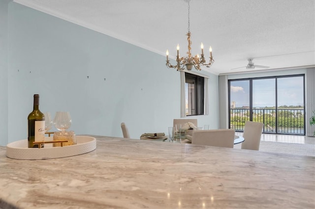 unfurnished dining area featuring a textured ceiling, ceiling fan with notable chandelier, and crown molding