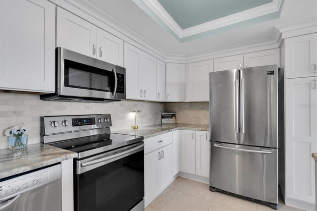 kitchen with white cabinetry, light stone countertops, crown molding, and appliances with stainless steel finishes