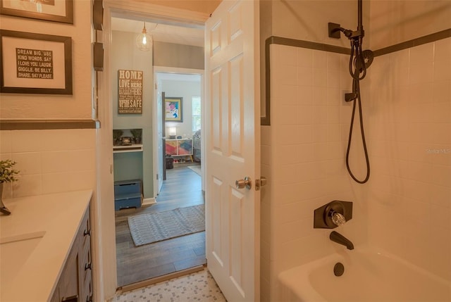 bathroom with vanity, tiled shower / bath, and hardwood / wood-style flooring