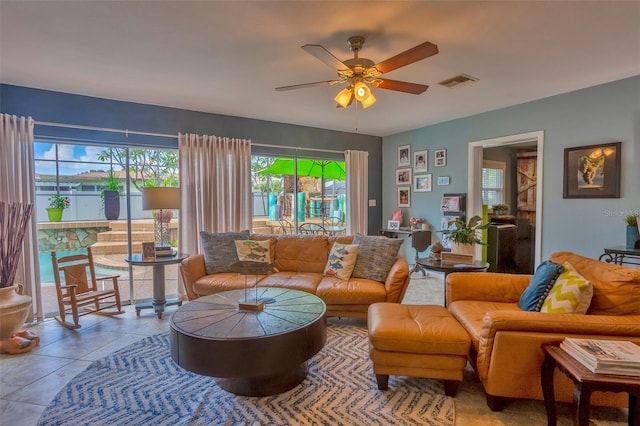 tiled living room with ceiling fan