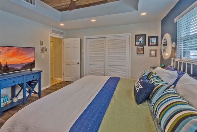 bedroom featuring wood ceiling, dark wood-type flooring, and a closet