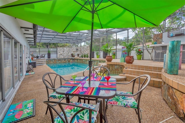 view of patio featuring a lanai and a fenced in pool