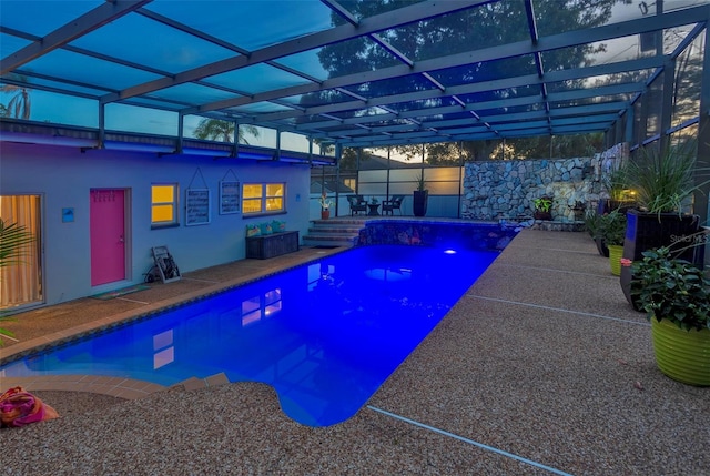 view of swimming pool with a patio and a lanai