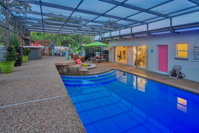 view of swimming pool featuring a patio area and glass enclosure