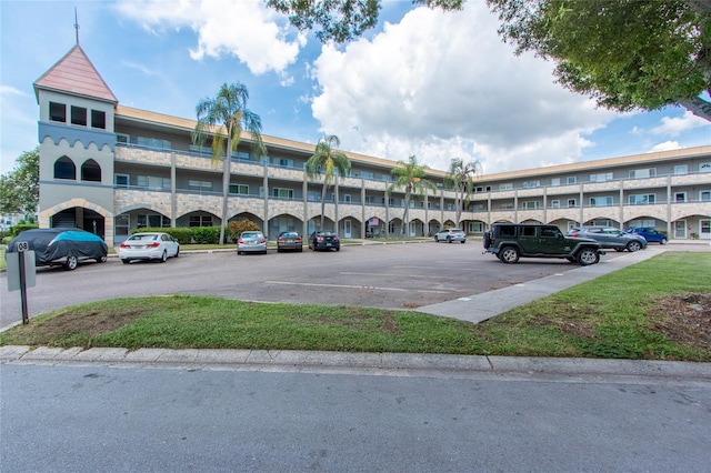 view of building exterior with uncovered parking