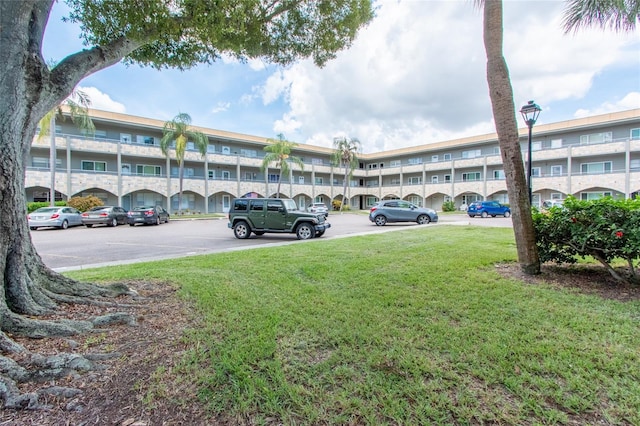 view of building exterior with uncovered parking