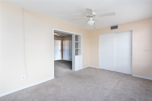 unfurnished bedroom with a ceiling fan, a closet, visible vents, and carpet flooring