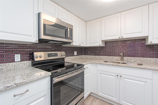 kitchen featuring tasteful backsplash, appliances with stainless steel finishes, and sink