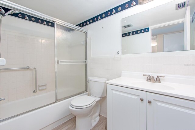 full bathroom with hardwood / wood-style floors, tile walls, backsplash, toilet, and vanity