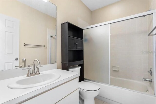 full bathroom featuring toilet, vanity, and bathtub / shower combination