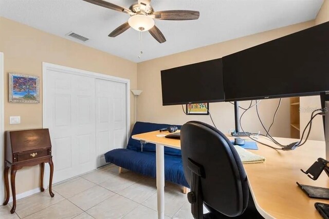 tiled home office featuring ceiling fan