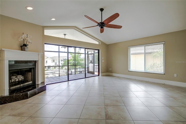 unfurnished living room featuring light tile patterned floors, ceiling fan, and a wealth of natural light