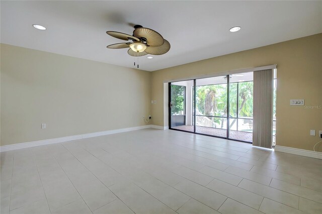 empty room featuring ceiling fan and light tile patterned flooring