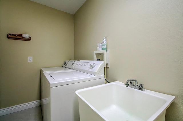 washroom with washer and dryer and sink