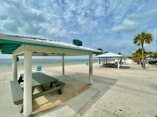 exterior space featuring a water view, a gazebo, and a beach view