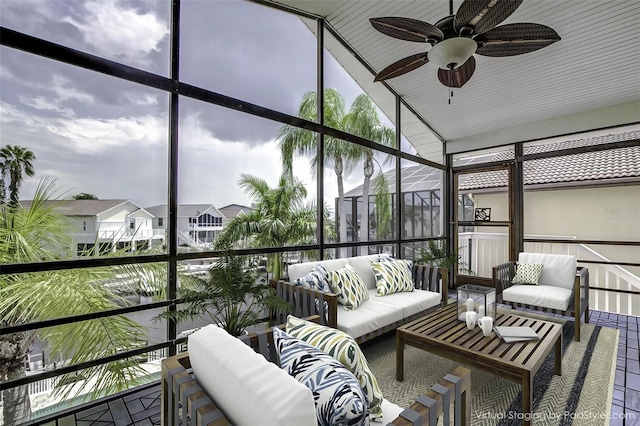 sunroom / solarium featuring ceiling fan and vaulted ceiling