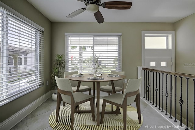 tiled dining area featuring ceiling fan